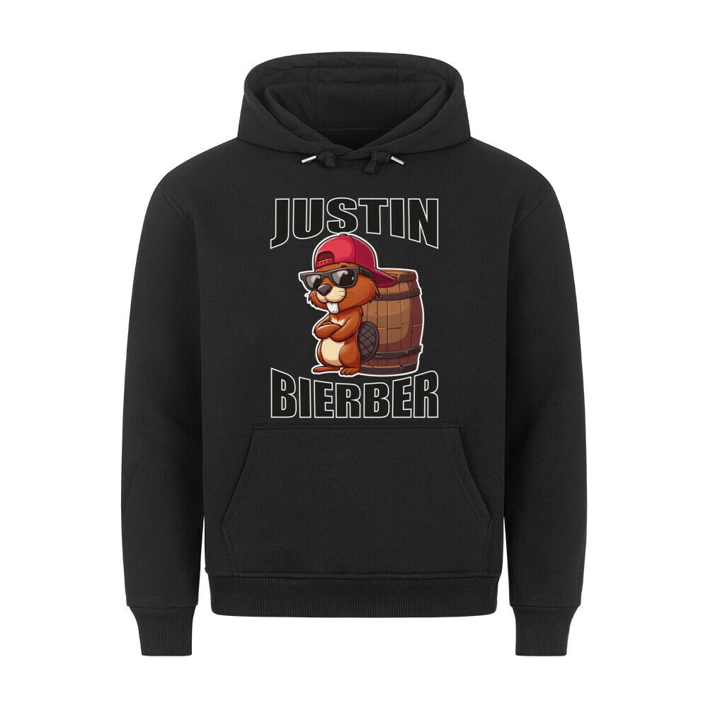 Schwarzer Hoodie mit humorvollem Design. In der Mitte ist ein cartoonartiger Biber mit Sonnenbrille und roter Basecap zu sehen, der vor einem Holzfass sitzt. Darüber steht in großen, Buchstaben „JUSTIN“, darunter „BIERBER“. Das Design spielt humorvoll auf den Namen „Justin Bieber“ an und kombiniert ihn mit „Bier“ und einem Biber.