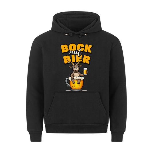 Schwarzer Hoodie. Auf der Vorderseite ist ein stilisierter, brauner Ziegenbock mit einem gelben Bierkrug in der Hand abgebildet. Der Bock sitzt in einer großen, goldenen Bierkrug-Silhouette. Über dem Bock steht der Schriftzug "BOCK auf BIER", wobei "BOCK" und "BIER" in gelber Farbe und "auf" in weißer Farbe dargestellt ist.