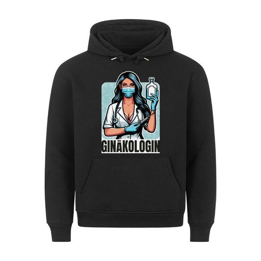 Schwarzer Hoodie. Auf der Vorderseite ist eine stilisierte, comicartige Illustration einer Ärztin mit langem, dunklem Haar, einer medizinischen Maske und einem Stethoskop. Sie hält eine Spritze und eine Flasche in den Händen. Unter der Illustration steht der Text "GINÄKOLOGIN" in weißen Buchstaben.